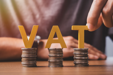 The word VAT on a stack of pennies